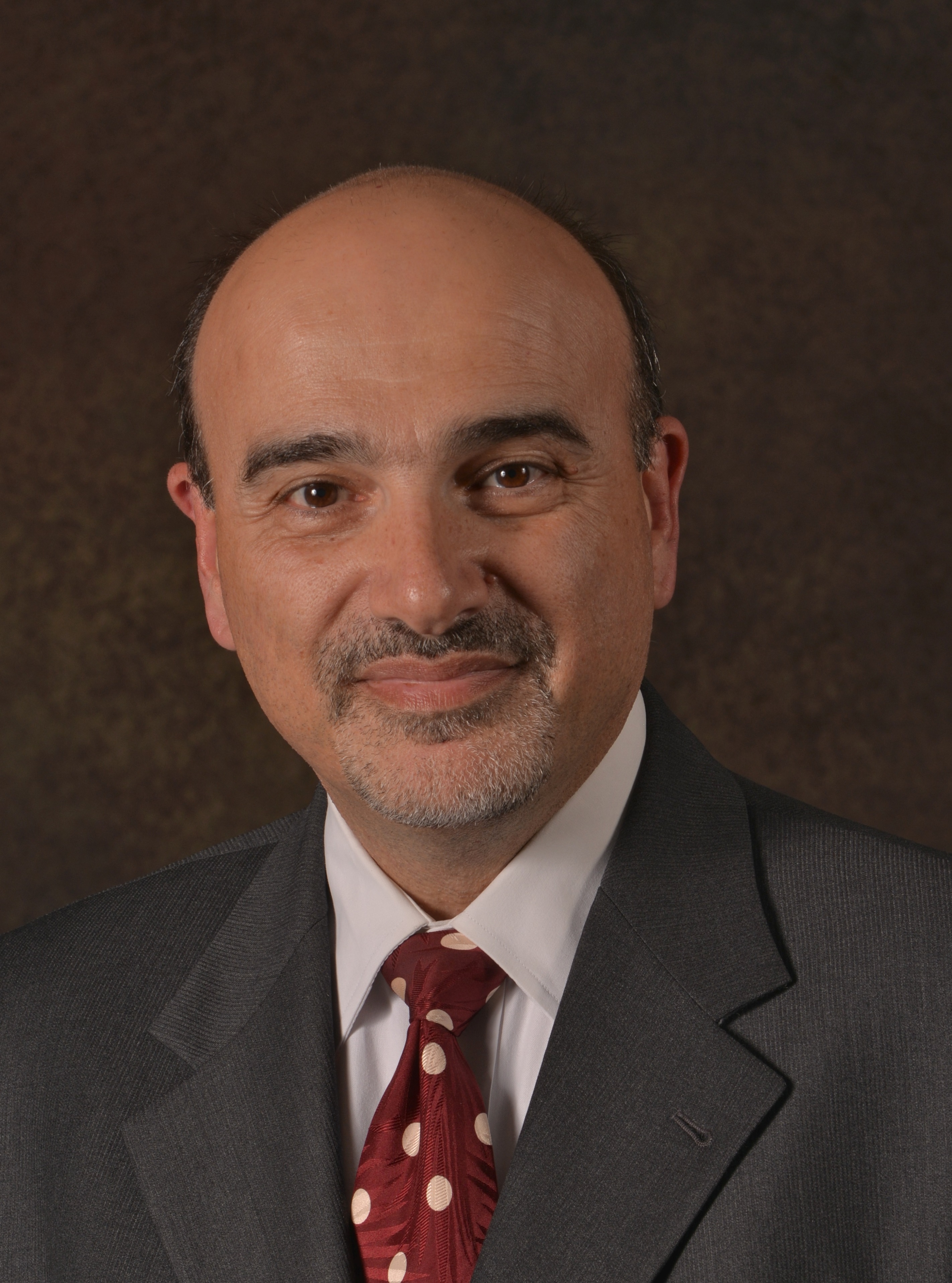 Middle aged white man in a suit and tie